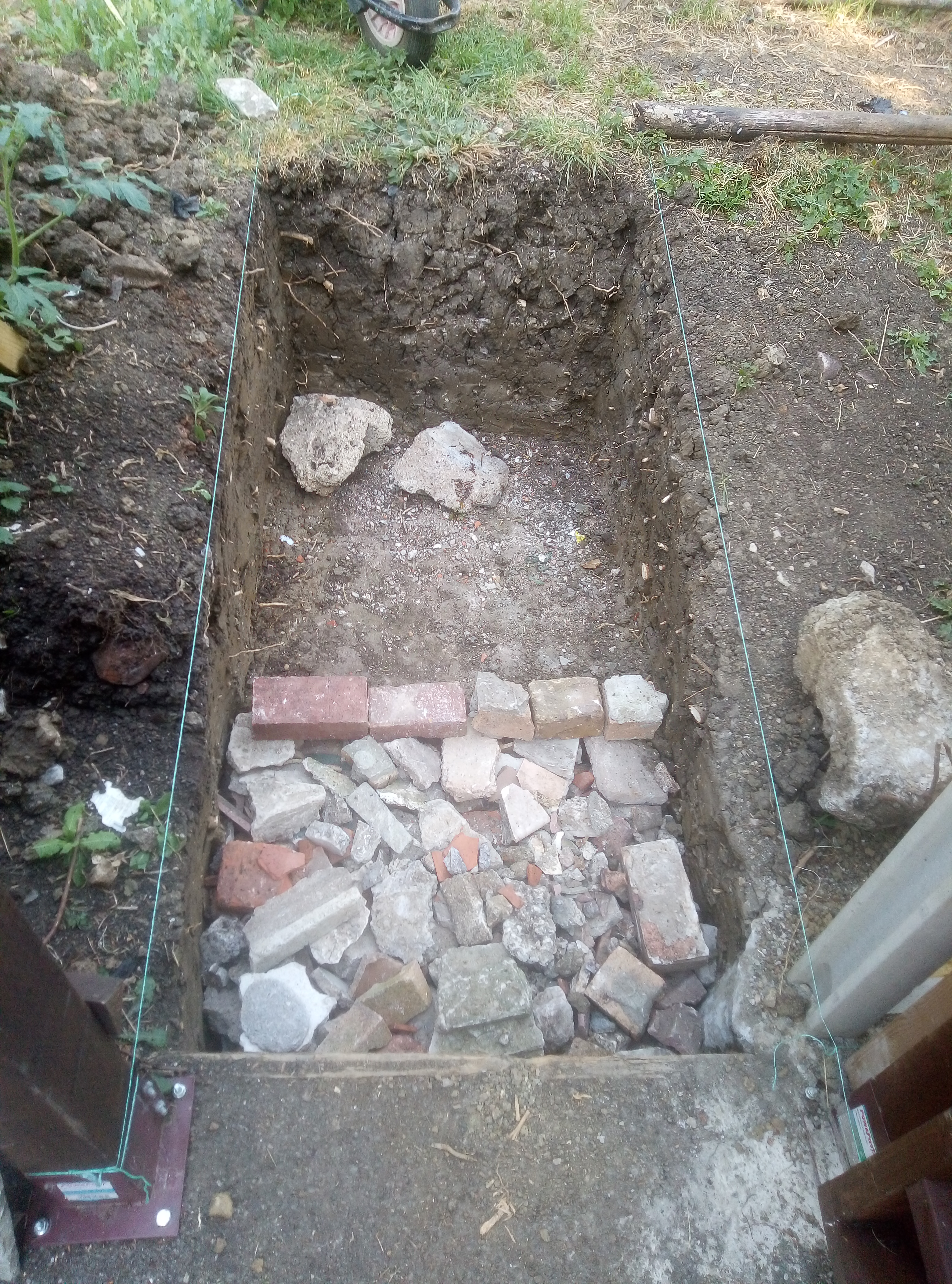 Pit dug for levelling garden entrance