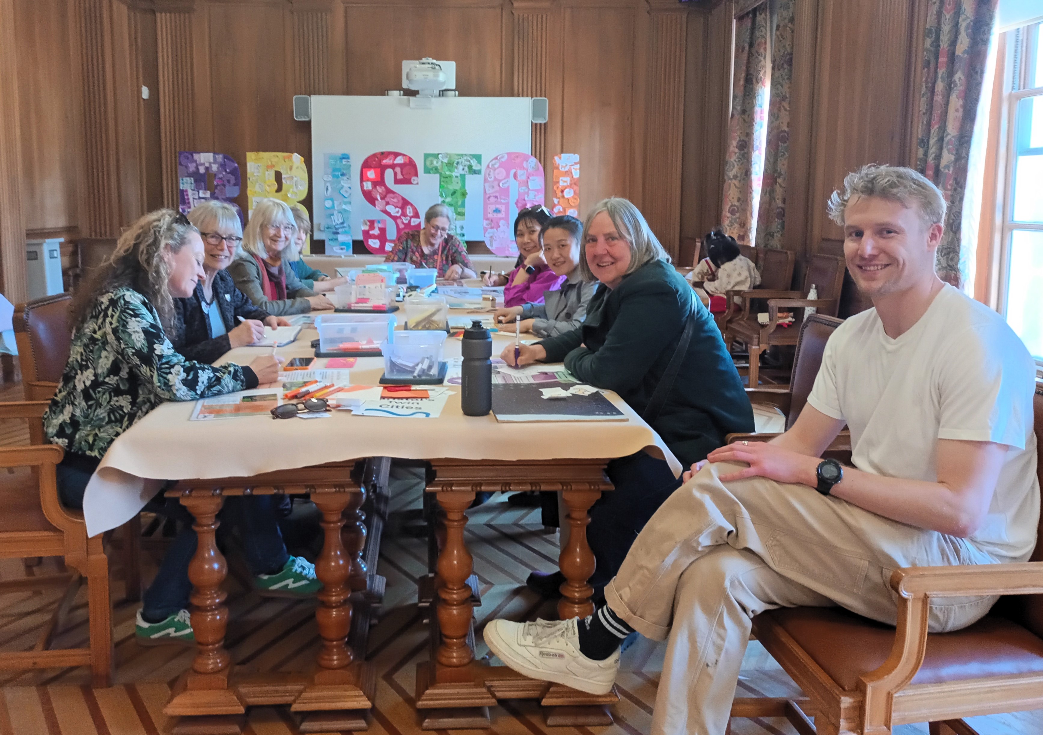 Residents sat at a table designing a Bristol Sign